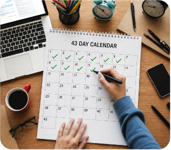 A 43-day planner being marked off at a desk